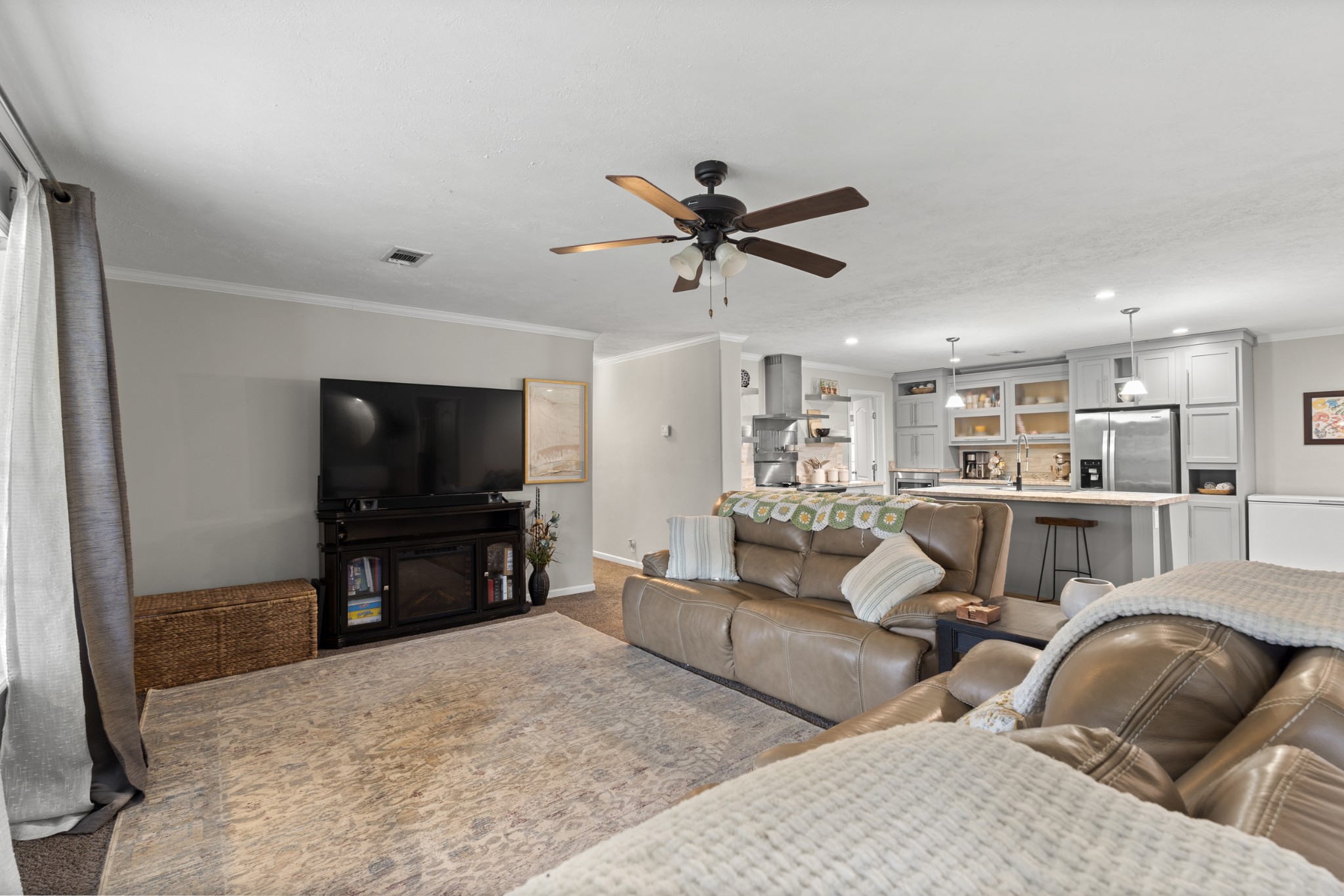 60 Edgewood Road McEwen, TN 37101 - Photo 17 of 56 a living room with furniture and a flat screen tv with kitchen view