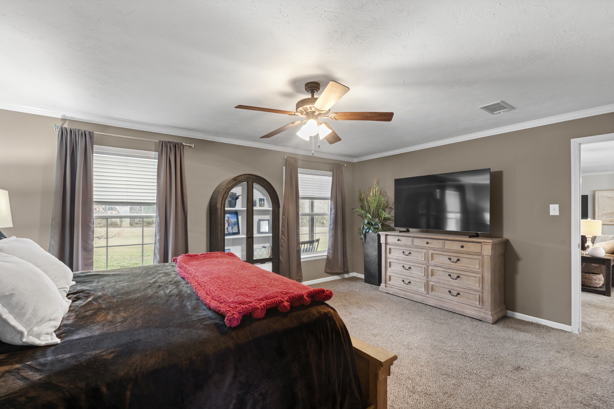 60 Edgewood Road McEwen, TN 37101 - Photo 27 of 56 a bedroom with a large bed and a flat tv screen on dresser