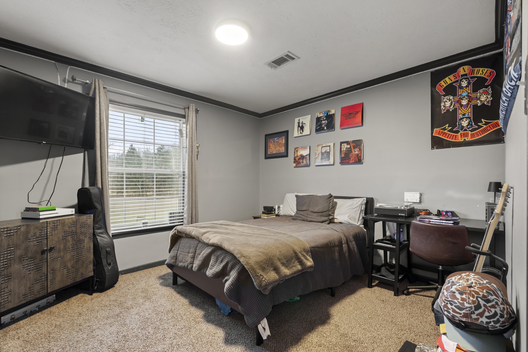 60 Edgewood Road McEwen, TN 37101 - Photo 34 of 56 a bedroom with a bed dresser and a flat screen tv