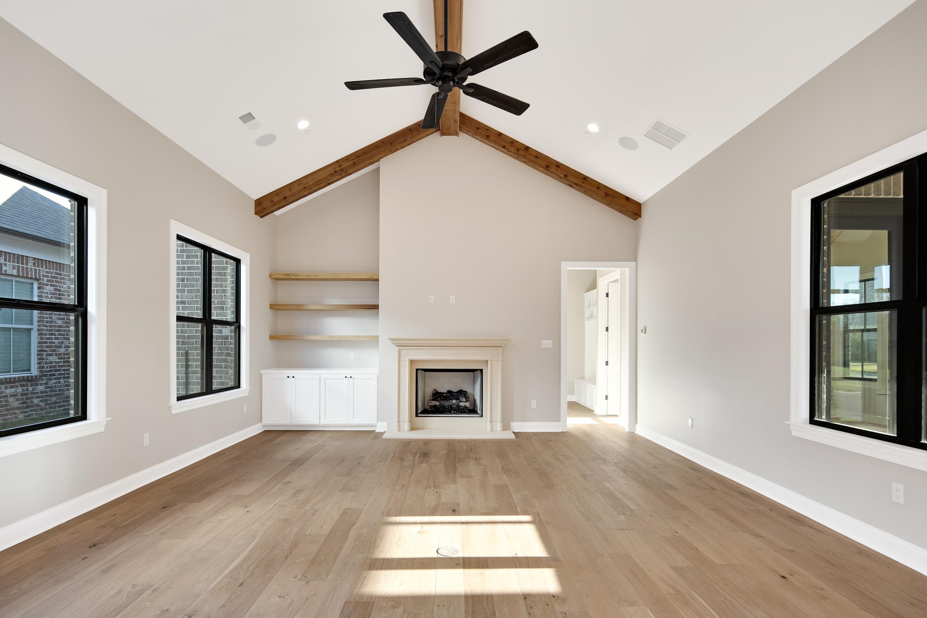 300 Mary Taylor Way Piperton, TN 38017 - Photo 15 of 36 Unfurnished living room featuring beam ceiling, high vaulted ceiling, light hardwood / wood-style flooring, and ceiling fan
