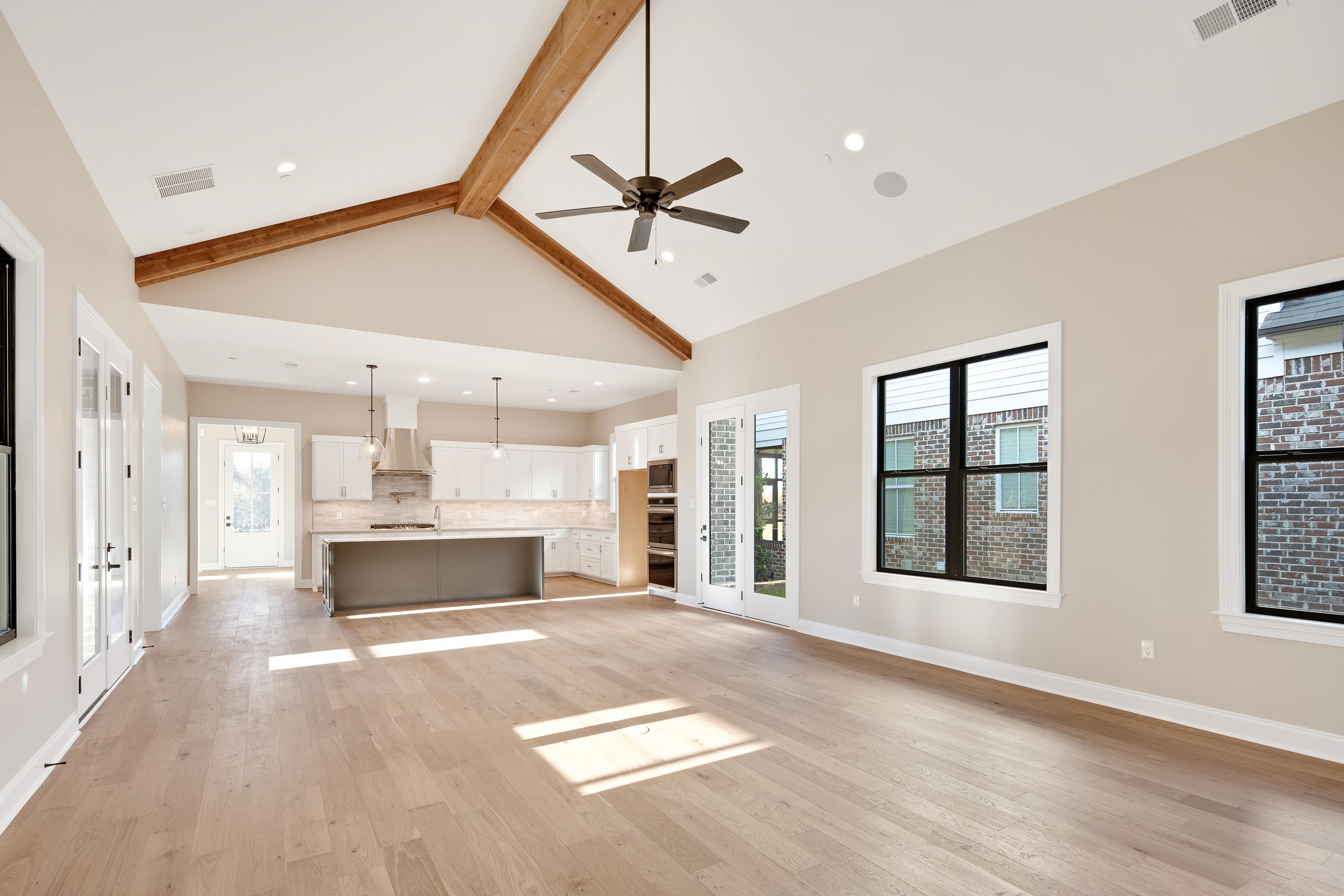 300 Mary Taylor Way Piperton, TN 38017 - Photo 16 of 36 Unfurnished living room with ceiling fan, plenty of natural light, high vaulted ceiling, and light wood-type flooring