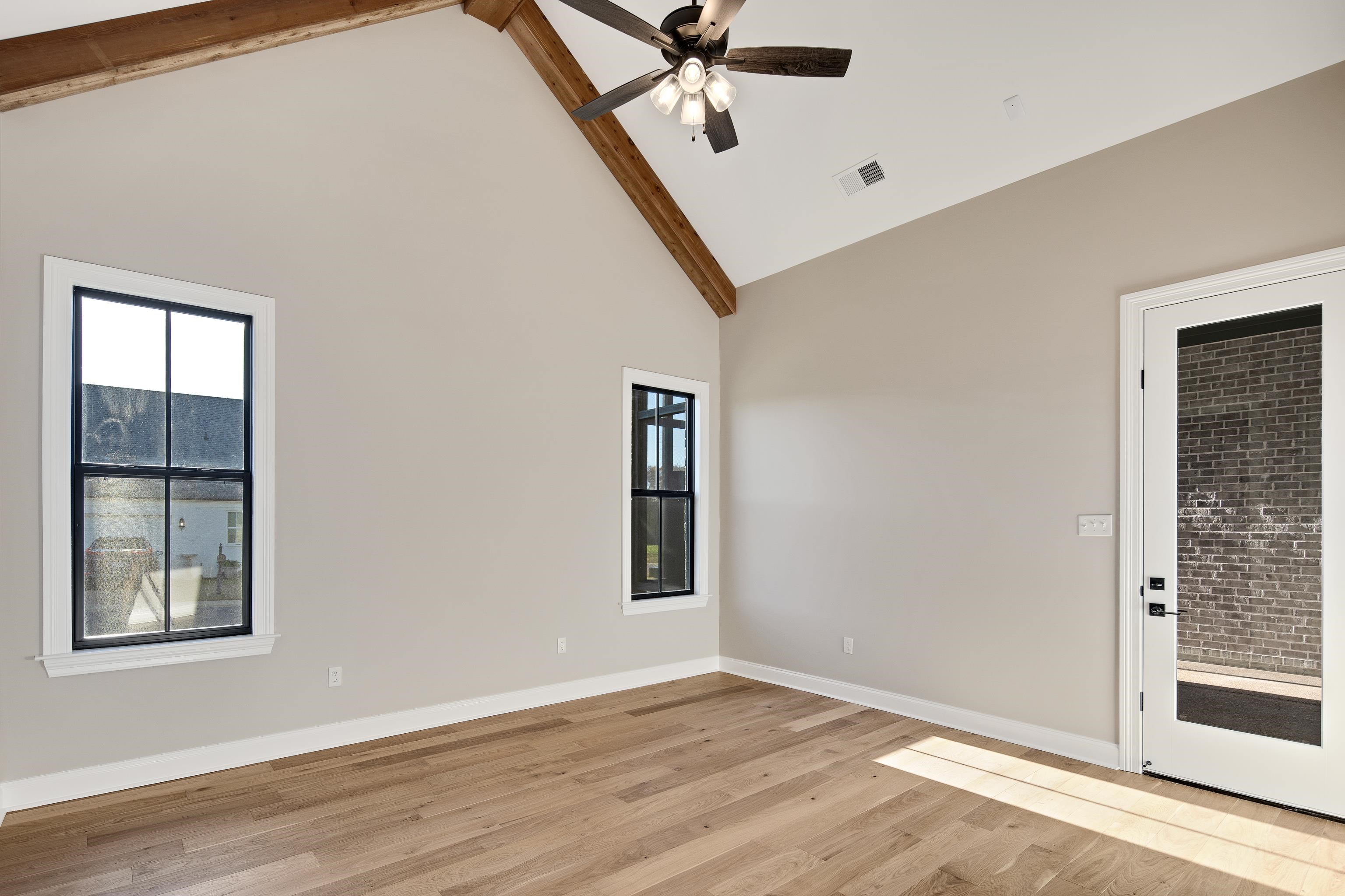 300 Mary Taylor Way Piperton, TN 38017 - Photo 18 of 36 Unfurnished room featuring ceiling fan, light hardwood / wood-style flooring, beamed ceiling, and high vaulted ceiling