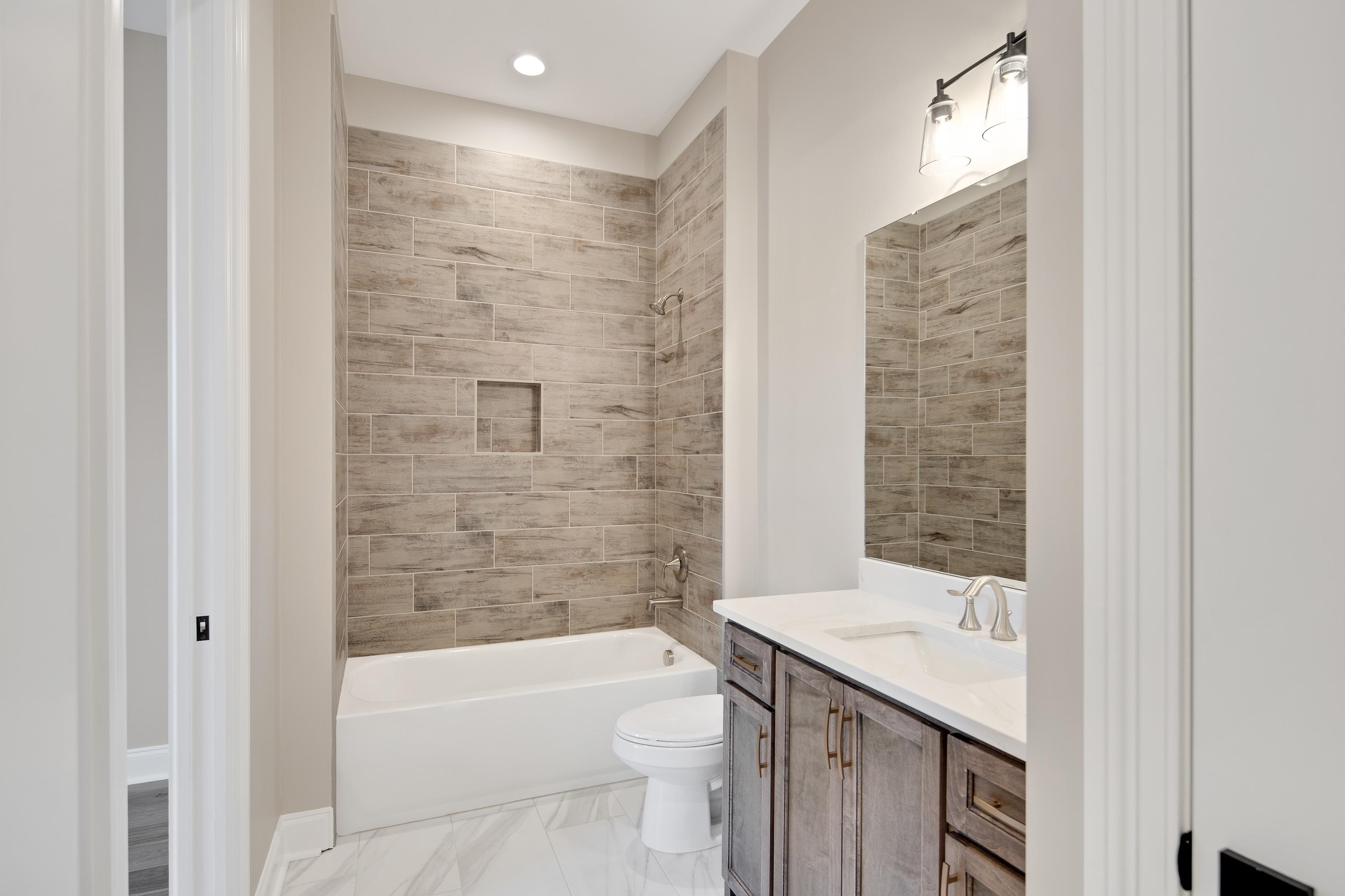 300 Mary Taylor Way Piperton, TN 38017 - Photo 22 of 36 Full bathroom featuring tiled shower / bath combo, toilet, and vanity