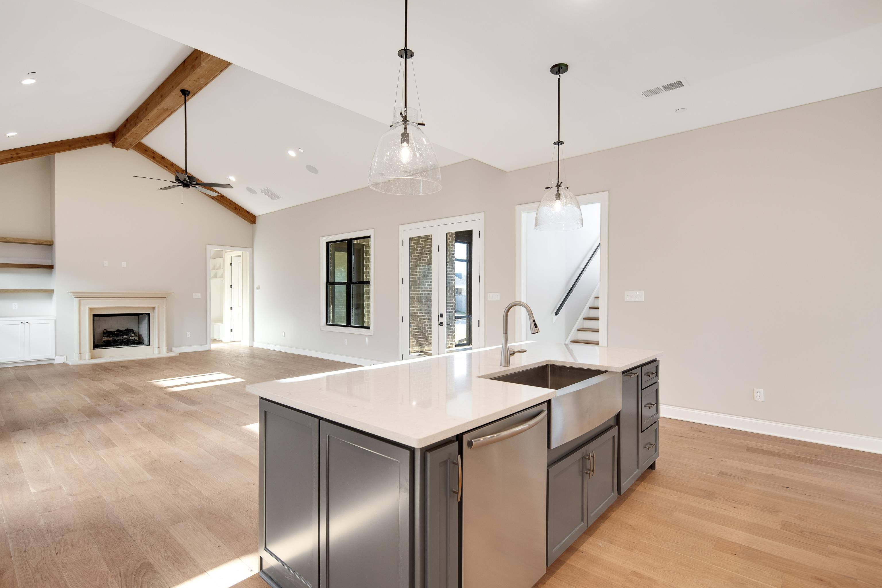 300 Mary Taylor Way Piperton, TN 38017 - Photo 23 of 36 Kitchen featuring sink, stainless steel dishwasher, decorative light fixtures, a center island with sink, and light wood-type flooring