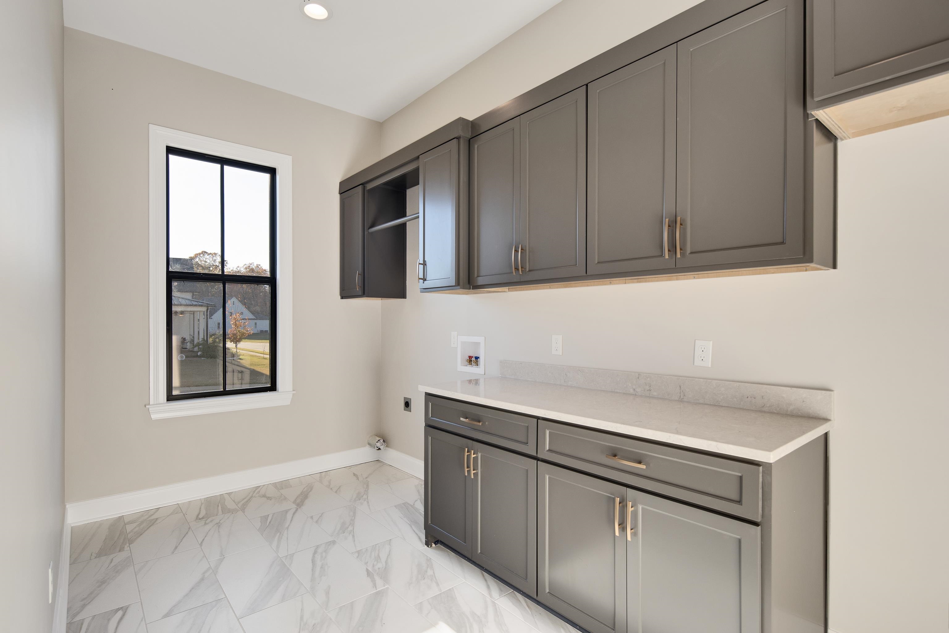 300 Mary Taylor Way Piperton, TN 38017 - Photo 26 of 36 a kitchen with stainless steel appliances granite countertop white cabinets and window