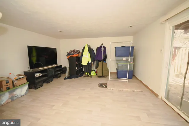 a view of a room with gym equipment and a flat screen tv