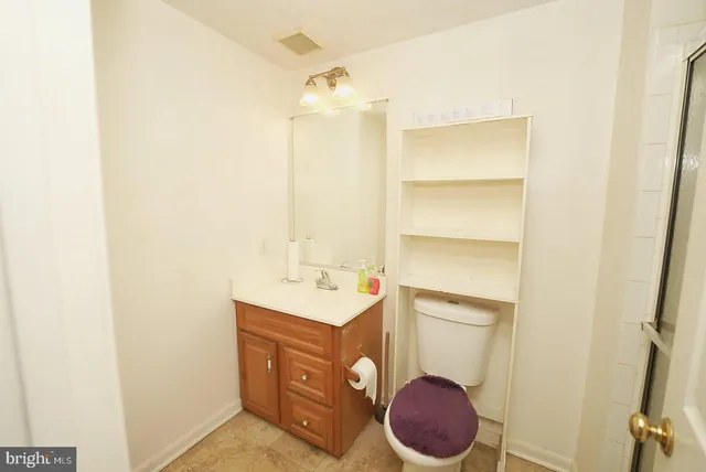 a bathroom with a toilet a sink and mirror