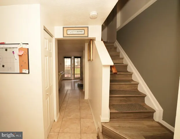 a view of a hallway with wooden floor and entryway