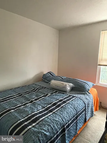 a bedroom with bed and a window