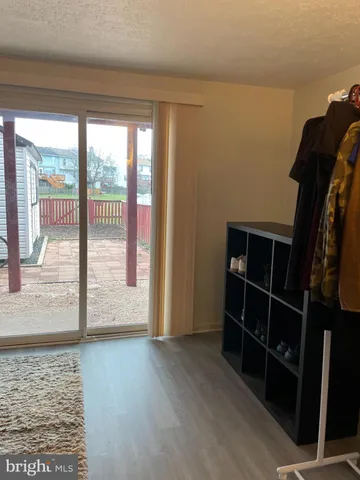 a view of entryway with wooden floor and door