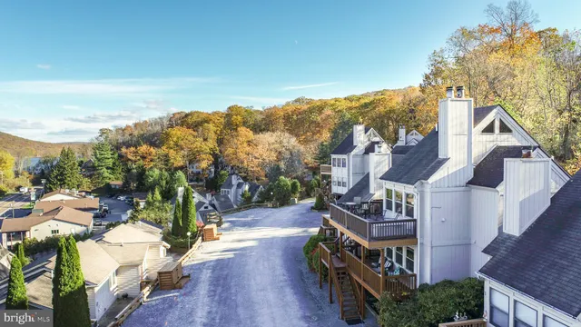 a view of a house with wooden stairs yard and outdoor seating