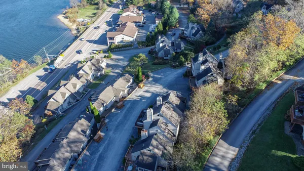 an aerial view of a house with a yard and outdoor seating