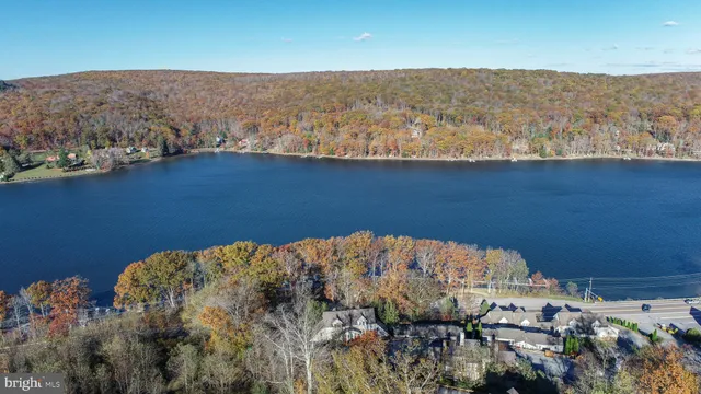 a view of residential houses with outdoor space and lake view