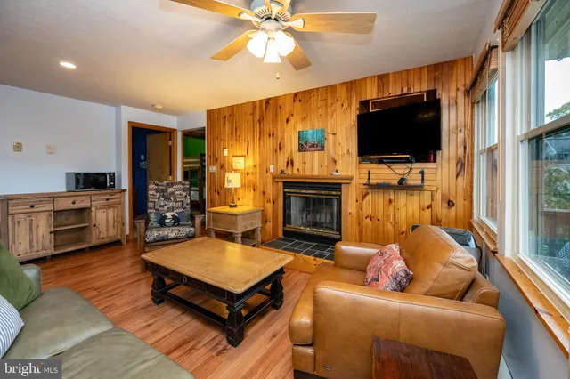 a living room with furniture a flat screen tv and a fireplace