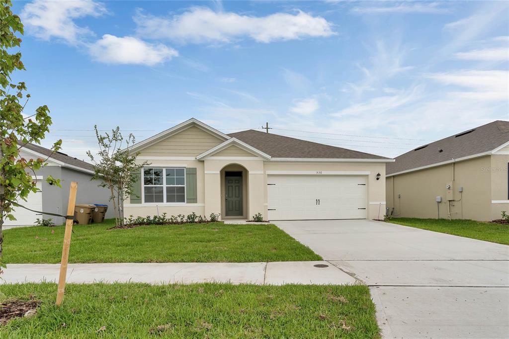 536 Talisi Loop St. Cloud, FL 34771 - Photo 1 of 1 a front view of a house with a yard and garage