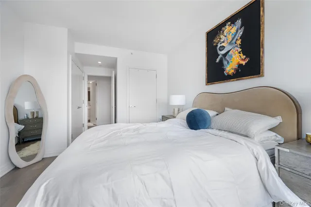 a bedroom with a bed and a painting on the wall