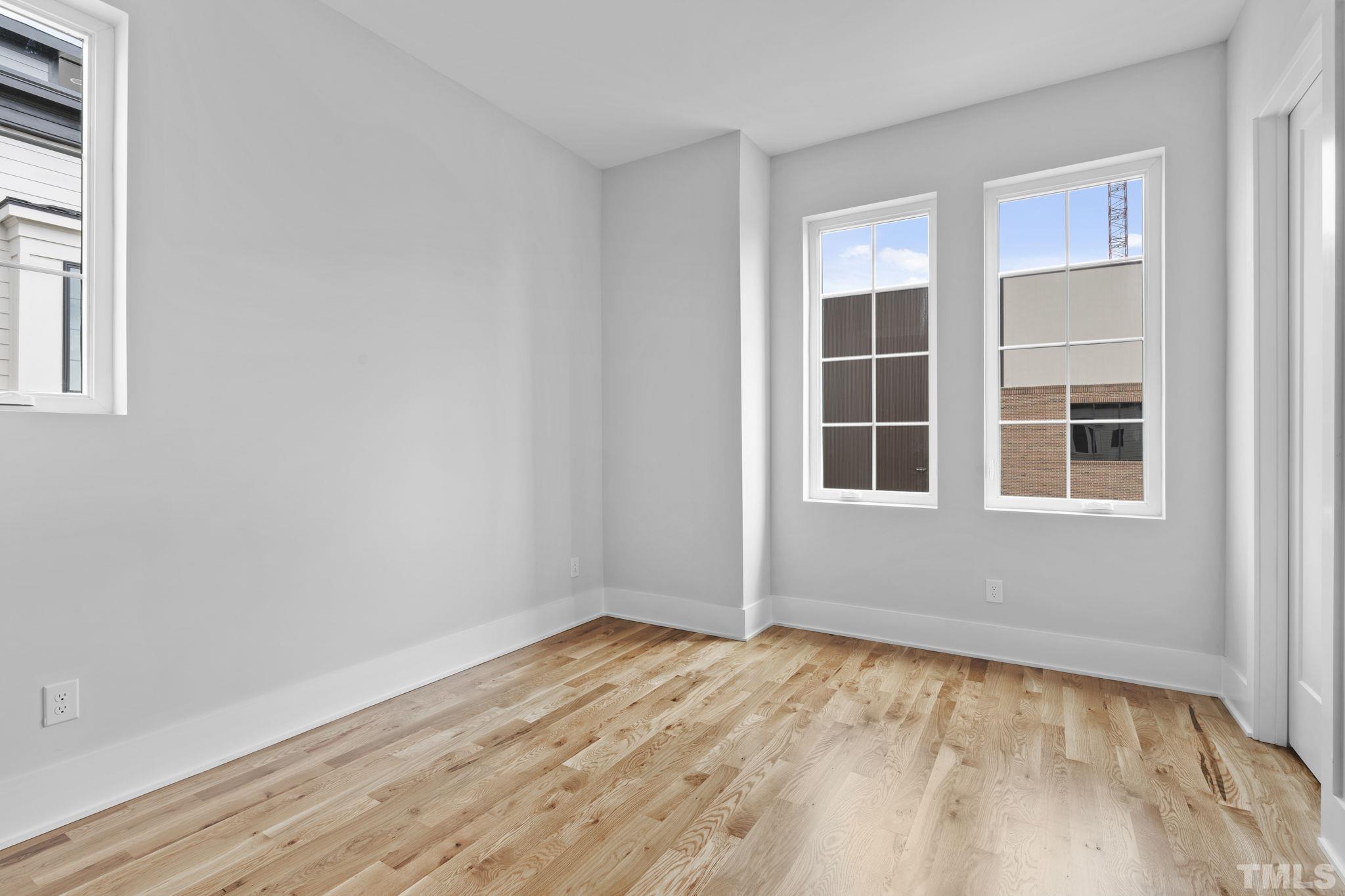 407 West Lenoir Street Raleigh, NC 27601 - Photo 17 of 42 a view of empty room with wooden floor and fan