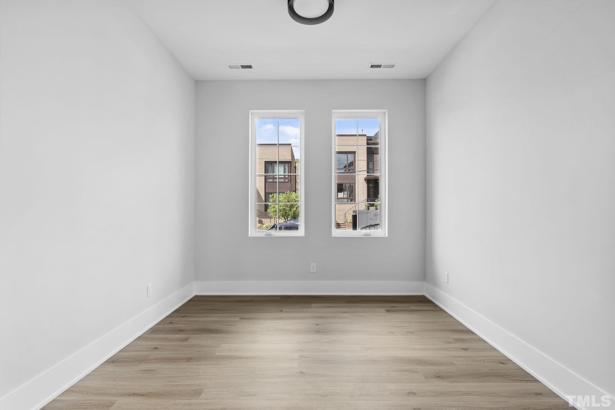 407 West Lenoir Street Raleigh, NC 27601 - Photo 20 of 42 an empty room with wooden door and window