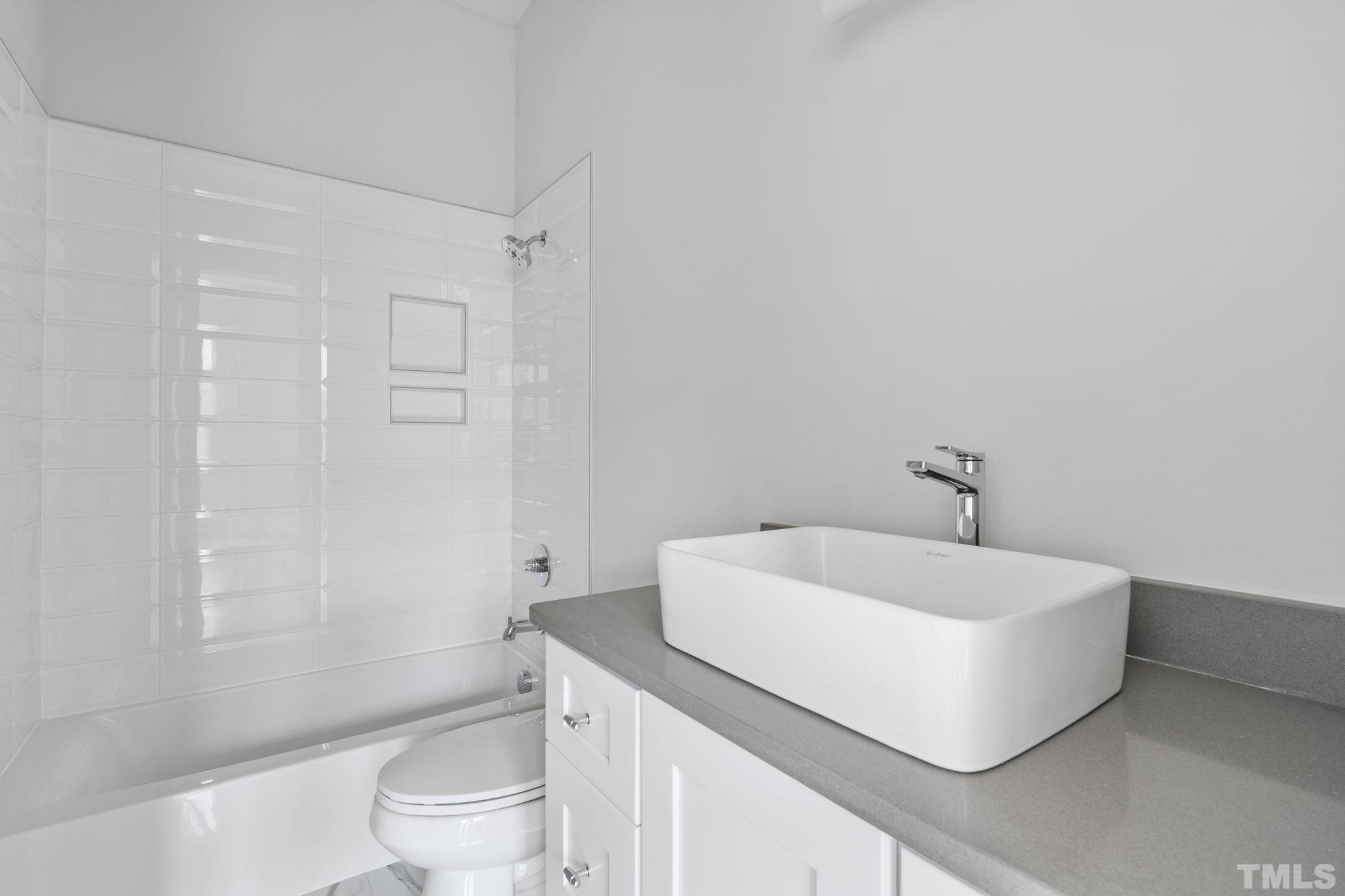 407 West Lenoir Street Raleigh, NC 27601 - Photo 22 of 42 a white bath tub sitting next to a white toilet