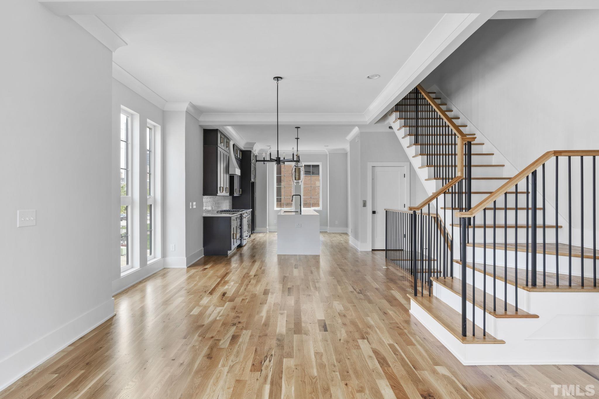 407 West Lenoir Street Raleigh, NC 27601 - Photo 3 of 42 a view of a kitchen with wooden floor and electronic appliances