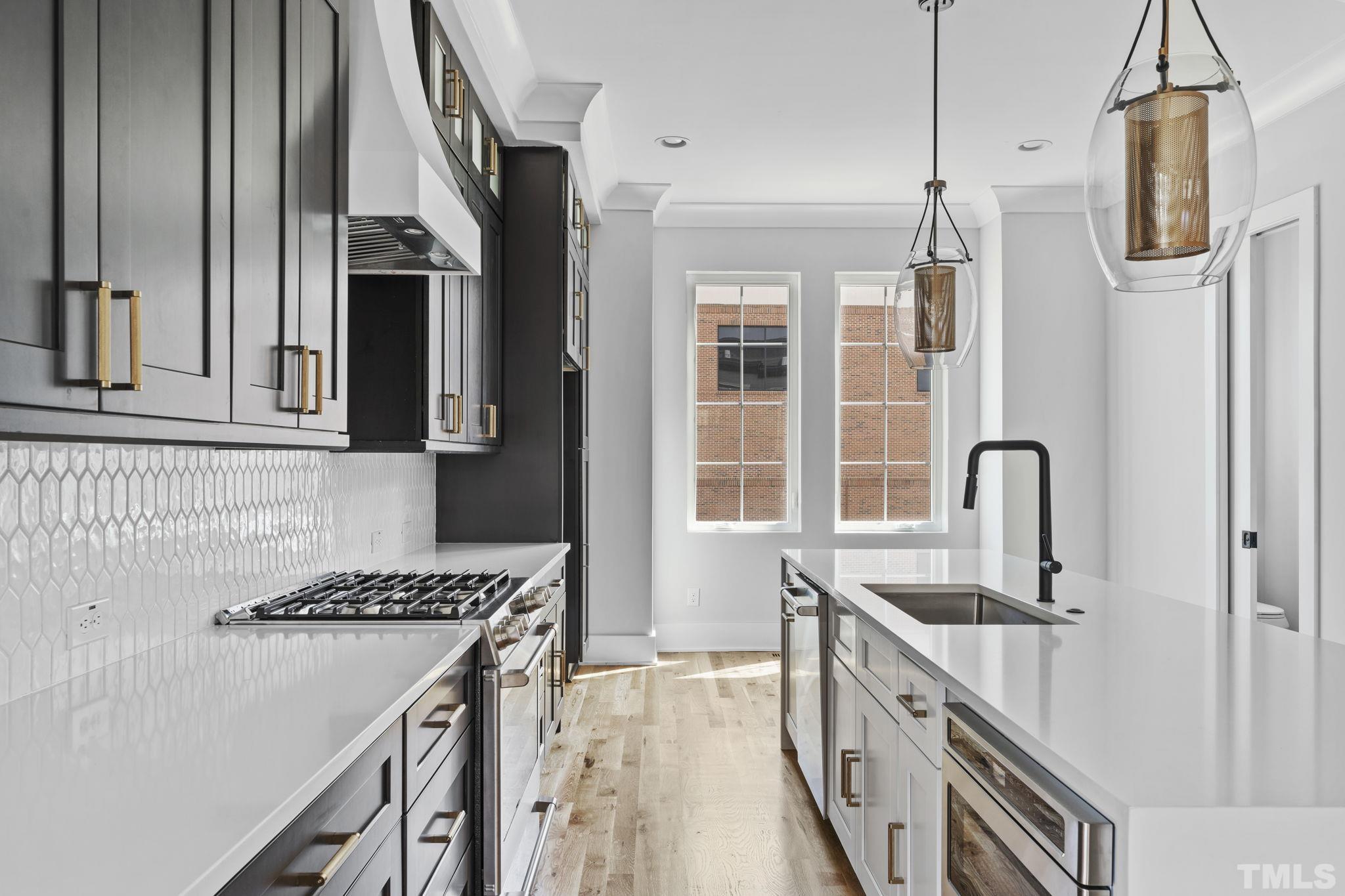 407 West Lenoir Street Raleigh, NC 27601 - Photo 5 of 42 a kitchen with stainless steel appliances granite countertop a sink and a refrigerator