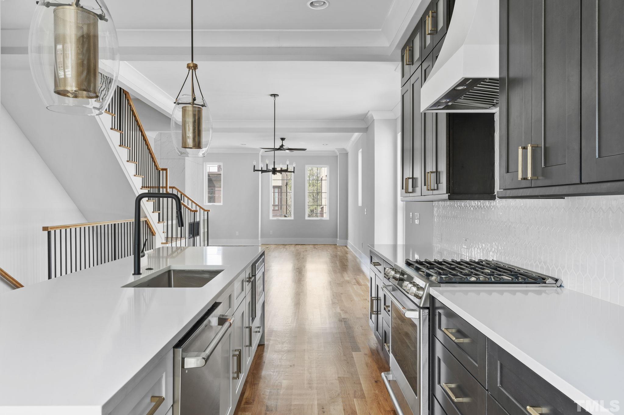 407 West Lenoir Street Raleigh, NC 27601 - Photo 7 of 42 a kitchen with kitchen island stainless steel appliances a sink stove and cabinets