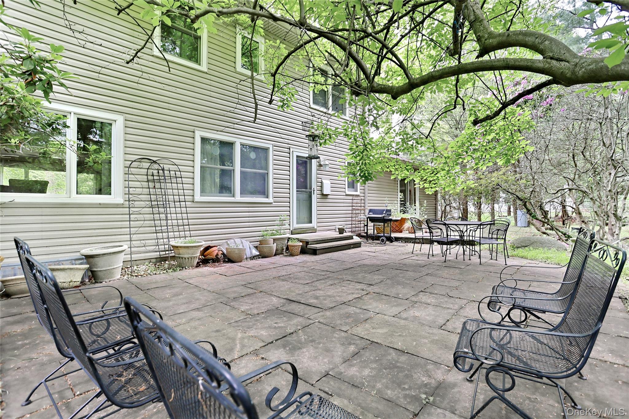 8 Swallow Avenue Spring Valley, NY 10977 - Photo 24 of 28 a view of a patio with table and chairs and potted plants