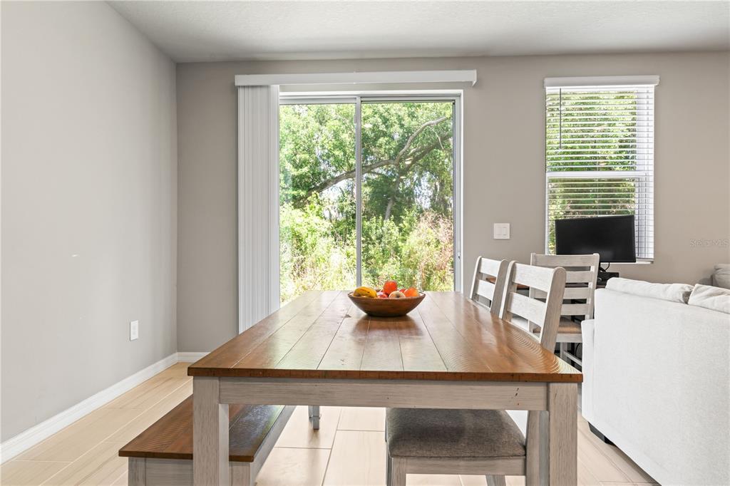 32502 Limitless Place Wesley Chapel, FL 33545 - Photo 20 of 67 a view of a dining room with furniture and window