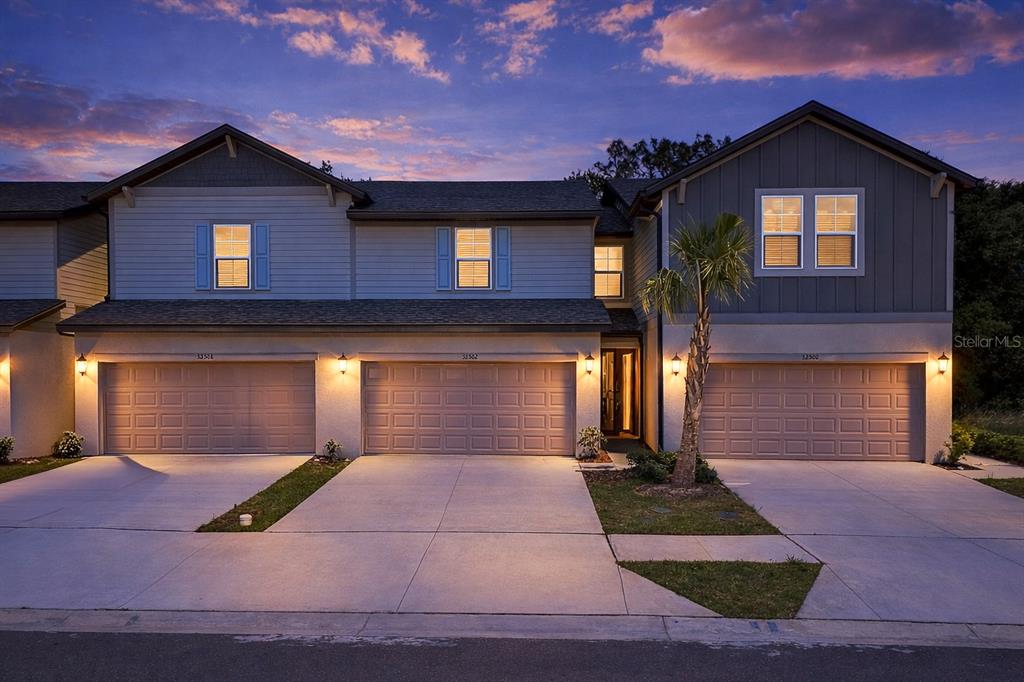 32502 Limitless Place Wesley Chapel, FL 33545 - Photo 2 of 67 a front view of a house with yard