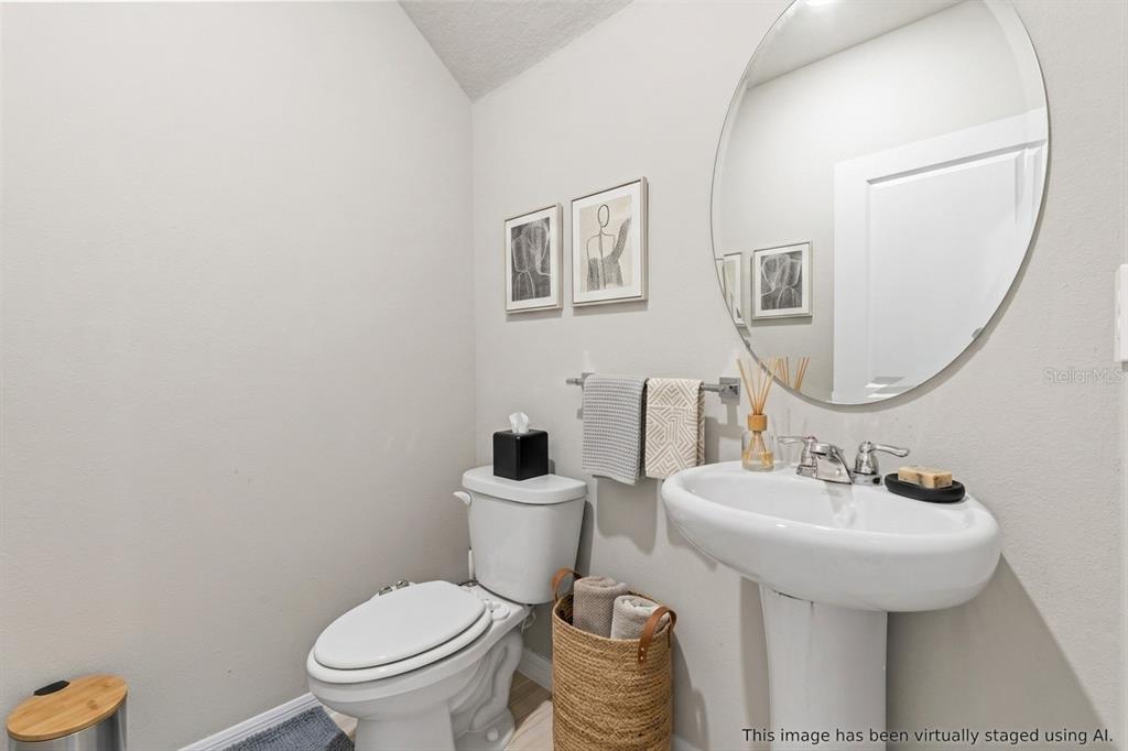 32502 Limitless Place Wesley Chapel, FL 33545 - Photo 21 of 67 a bathroom with a toilet a sink and mirror