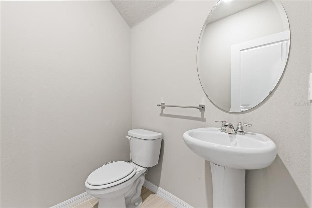 32502 Limitless Place Wesley Chapel, FL 33545 - Photo 22 of 67 a bathroom with a toilet sink and mirror