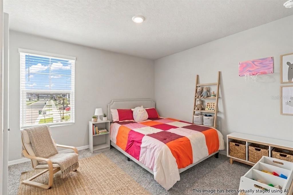32502 Limitless Place Wesley Chapel, FL 33545 - Photo 25 of 67 a bedroom with a bed and chair