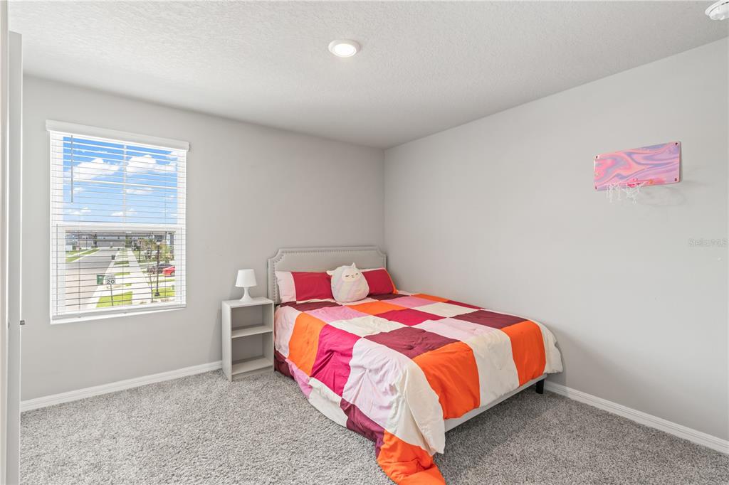 32502 Limitless Place Wesley Chapel, FL 33545 - Photo 26 of 67 a bedroom with a bed and a window