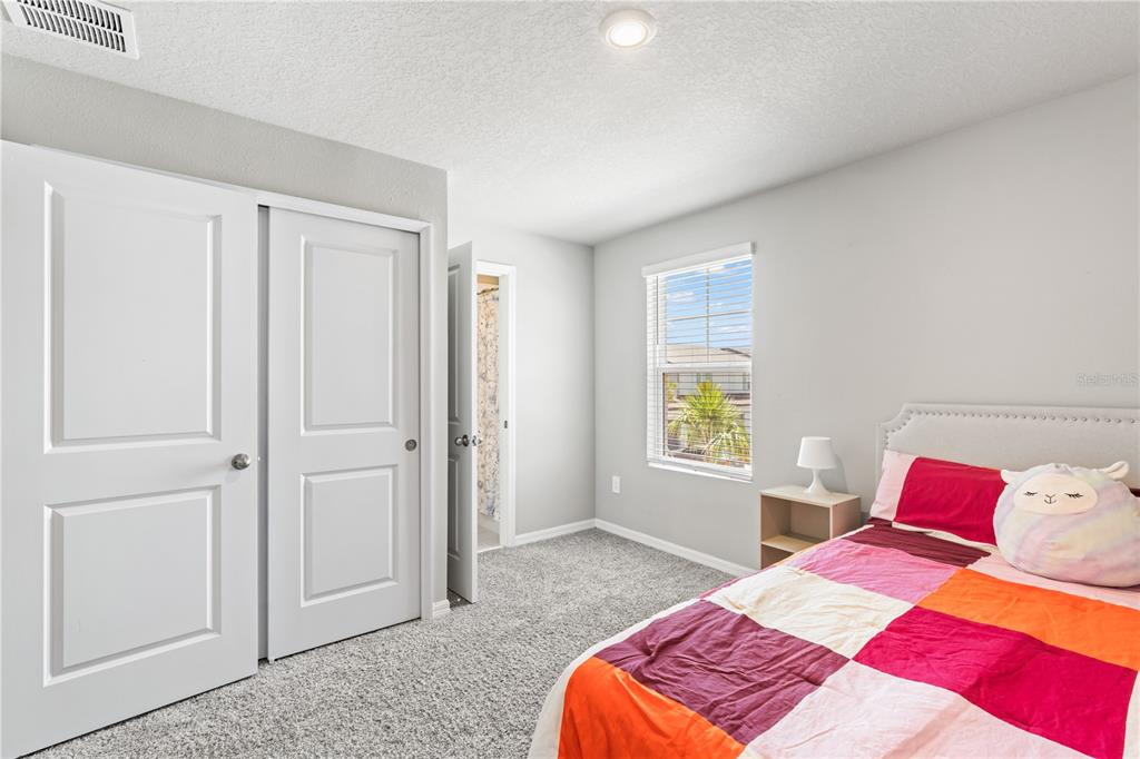 32502 Limitless Place Wesley Chapel, FL 33545 - Photo 27 of 67 a bedroom with a bed and a window