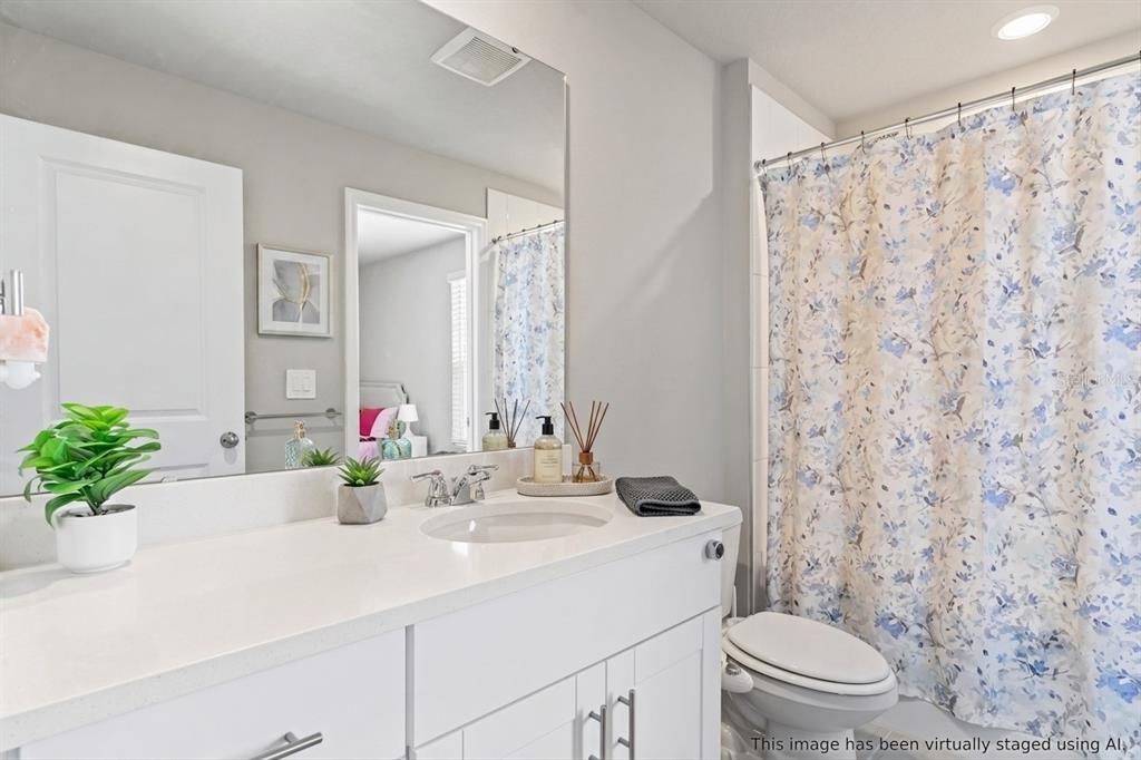 32502 Limitless Place Wesley Chapel, FL 33545 - Photo 28 of 67 a bathroom with a sink toilet and shower