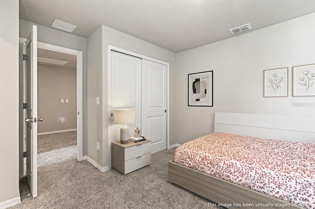 32502 Limitless Place Wesley Chapel, FL 33545 - Photo 31 of 67 a bedroom with a bed and a view of bathroom