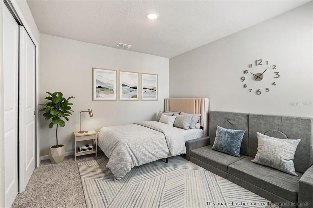 32502 Limitless Place Wesley Chapel, FL 33545 - Photo 33 of 67 a bedroom with a bed and a potted plant