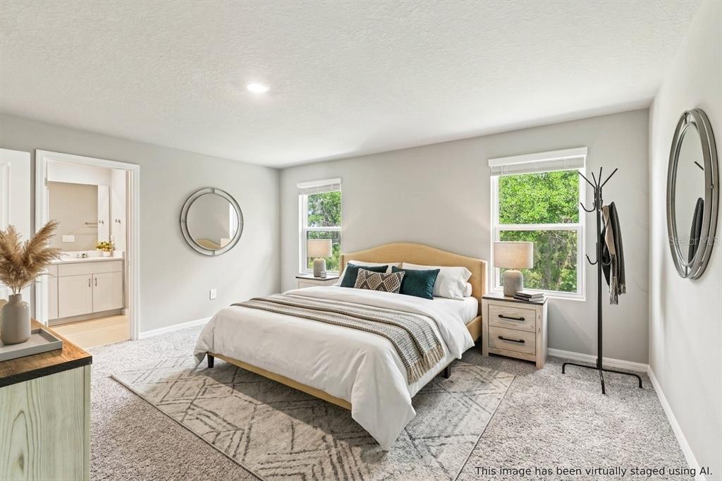 32502 Limitless Place Wesley Chapel, FL 33545 - Photo 37 of 67 a bedroom with a large bed and a window