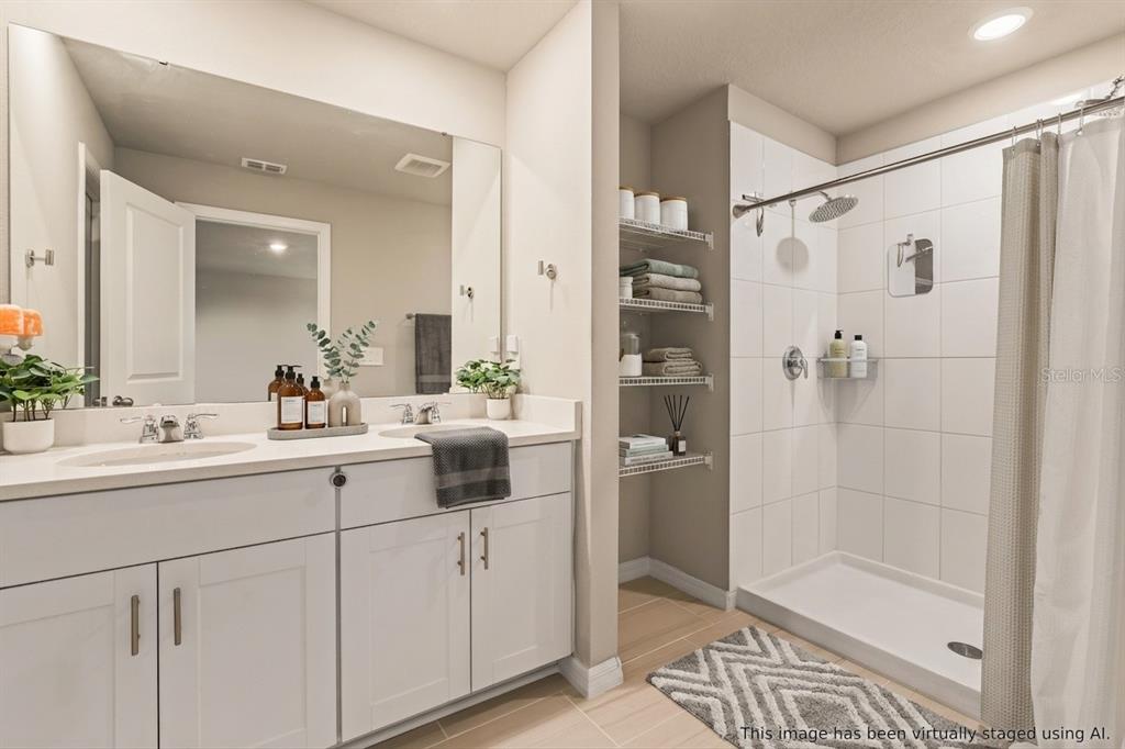 32502 Limitless Place Wesley Chapel, FL 33545 - Photo 43 of 67 a bathroom with a shower sink and mirror