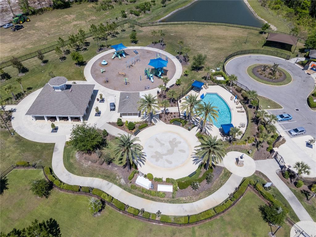 32502 Limitless Place Wesley Chapel, FL 33545 - Photo 63 of 67 an aerial view of a swimming pool with outdoor seating and yard