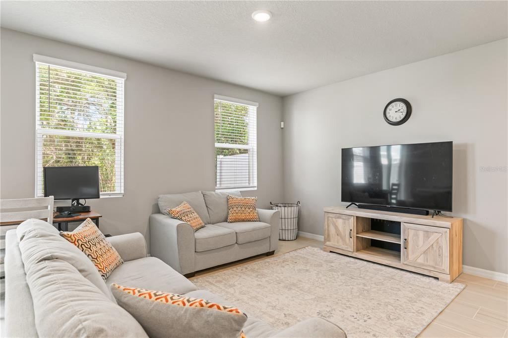 32502 Limitless Place Wesley Chapel, FL 33545 - Photo 7 of 67 a living room with furniture and a flat screen tv