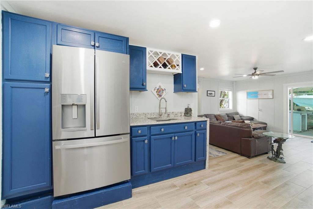 1286 Venetian Way Naples, FL 34110 - Photo 21 of 46 a kitchen with a refrigerator and a sink