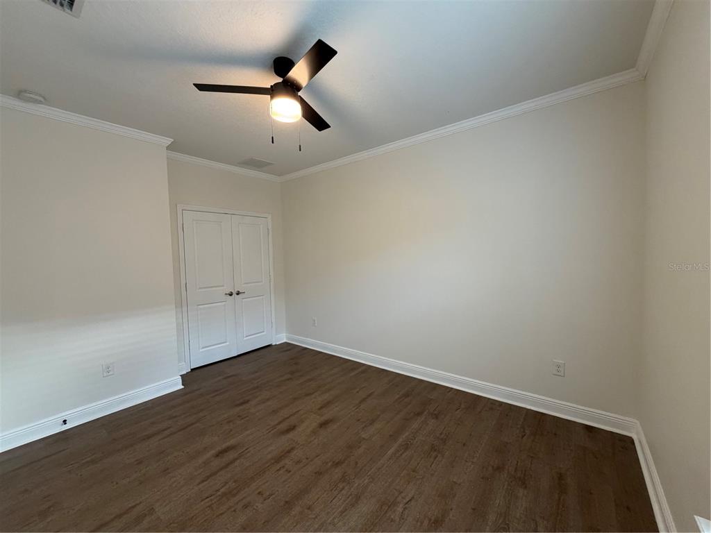 1736 West Walnut Street Tampa, FL 33607 - Photo 13 of 22 an empty room with wooden floor ceiling fan and window