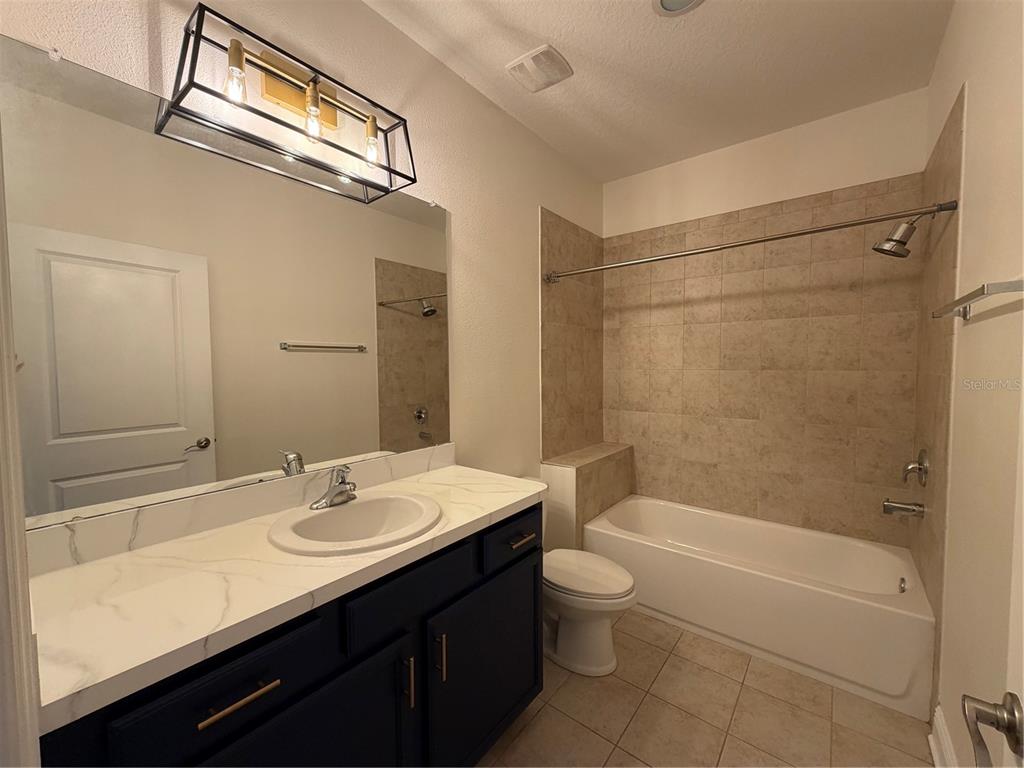 1736 West Walnut Street Tampa, FL 33607 - Photo 15 of 22 a bathroom with a sink a toilet and shower