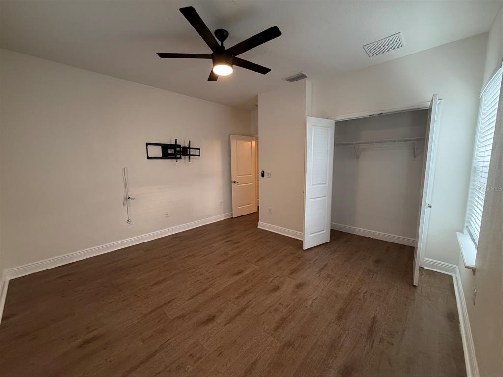 1736 West Walnut Street Tampa, FL 33607 - Photo 17 of 22 an empty room with wooden floor and windows