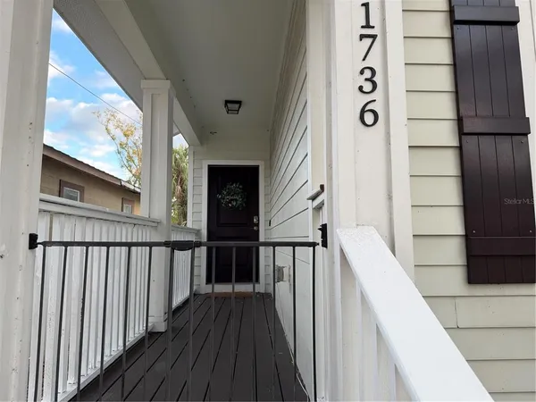 a view of a balcony with wooden floor and stairs