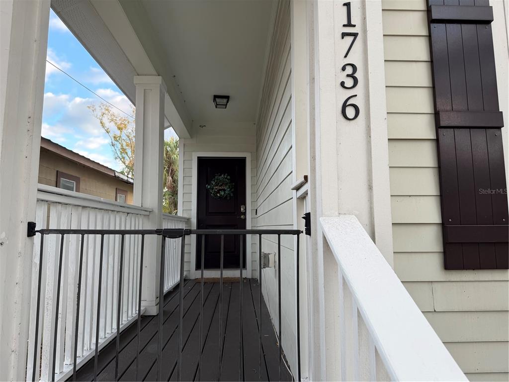 1736 West Walnut Street Tampa, FL 33607 - Photo 2 of 22 a view of a balcony with wooden floor and stairs