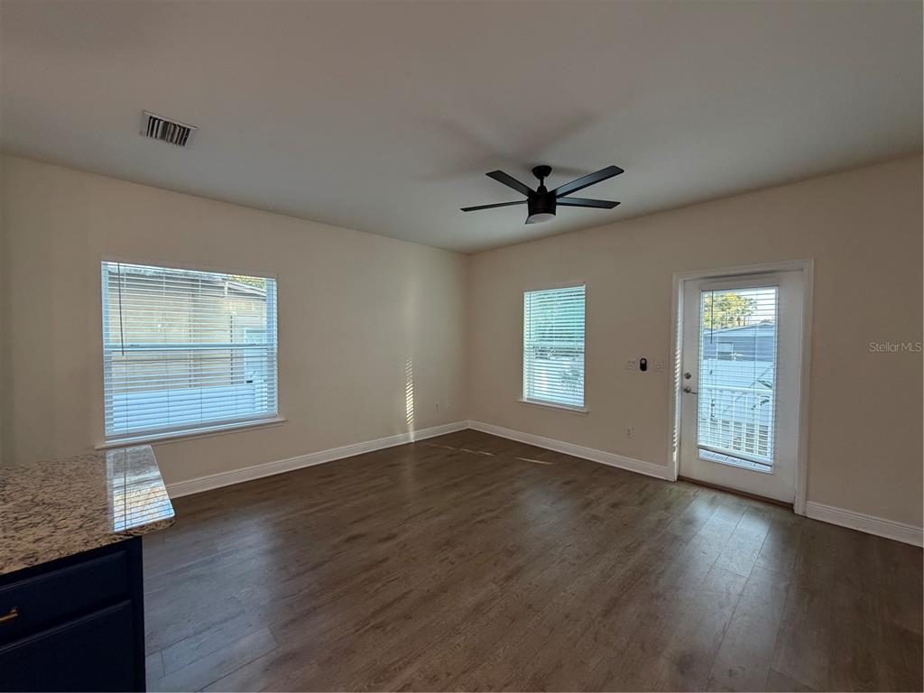 1736 West Walnut Street Tampa, FL 33607 - Photo 6 of 22 an empty room with wooden floor and windows