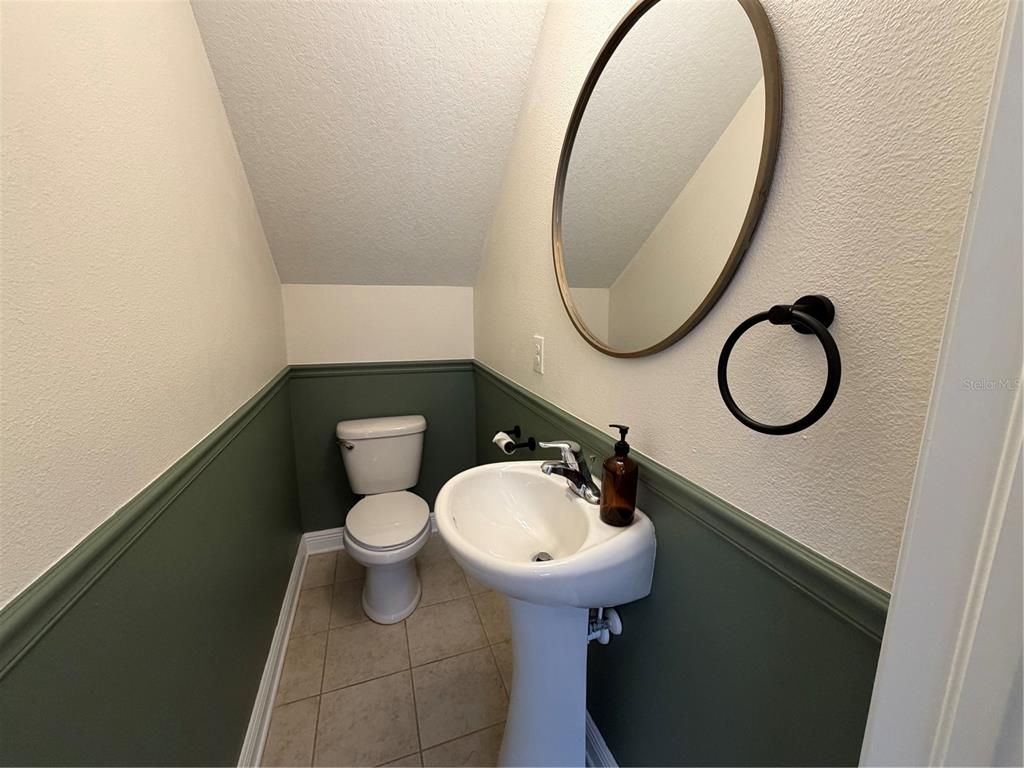 1736 West Walnut Street Tampa, FL 33607 - Photo 7 of 22 a bathroom with a toilet sink and mirror