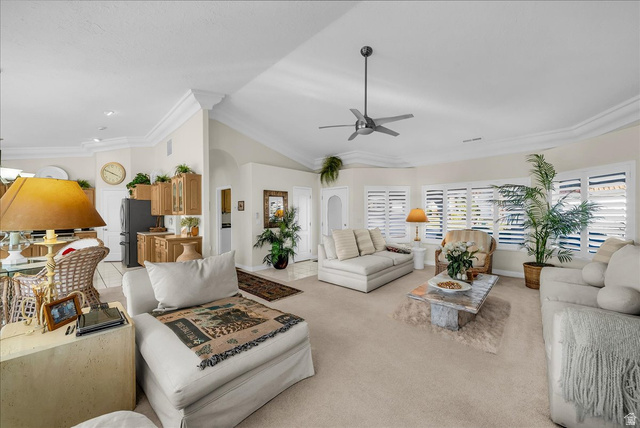 150 South Crystal Street, Unit 31 St. George, UT 84770 - Photo 9 of 20 Living room with a ceiling fan, crown molding, light carpet, lofted ceiling, and arched walkways